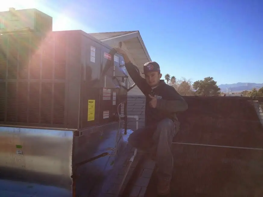 HVAC technician performing Boiler Repair on a rooftop unit in Marion